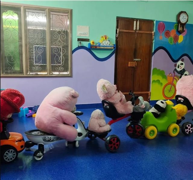 Ride-on toys in the playtime area at Kids Kingdom Playschool